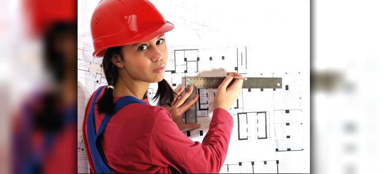 Professions woman Woman with red helmet at the drawing board.