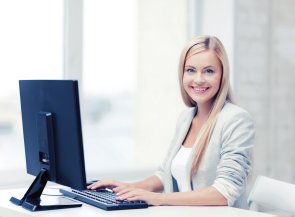 Woman sitting in front of screen and keyboard at office work.