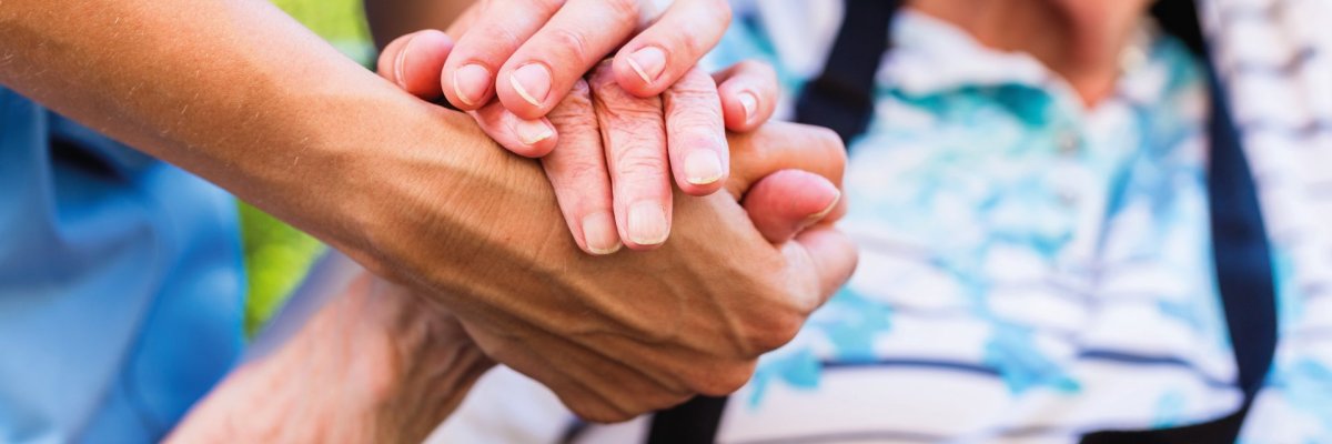 Nurse consoling senior woman holding her hand Nurse consoling senior woman holding her hand