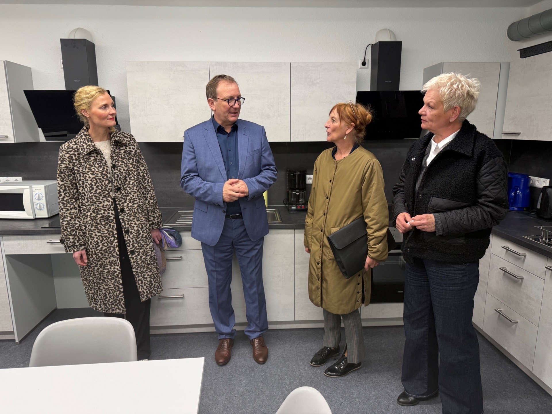 La foto fue tomada durante la visita in situ y muestra a la Directora Heike Hampe (2ª por la derecha) y a su adjunta, Anja Gerth (izquierda), en conversación con el Administrador del Distrito Markus Bauer y la Jefa de Departamento Anke Meyer (derecha).